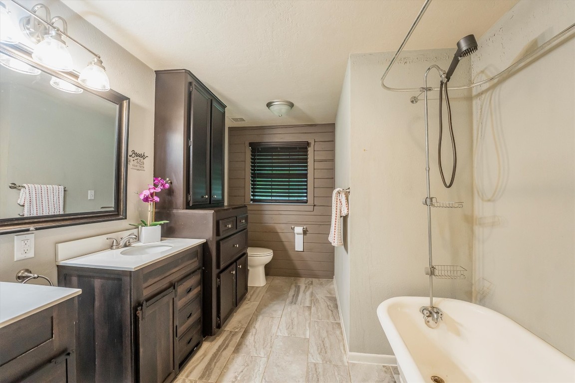 12049 Clark Lane Conroe, TX 77385 - Photo 19 of 40 a bathroom with a double vanity sink mirror and toilet