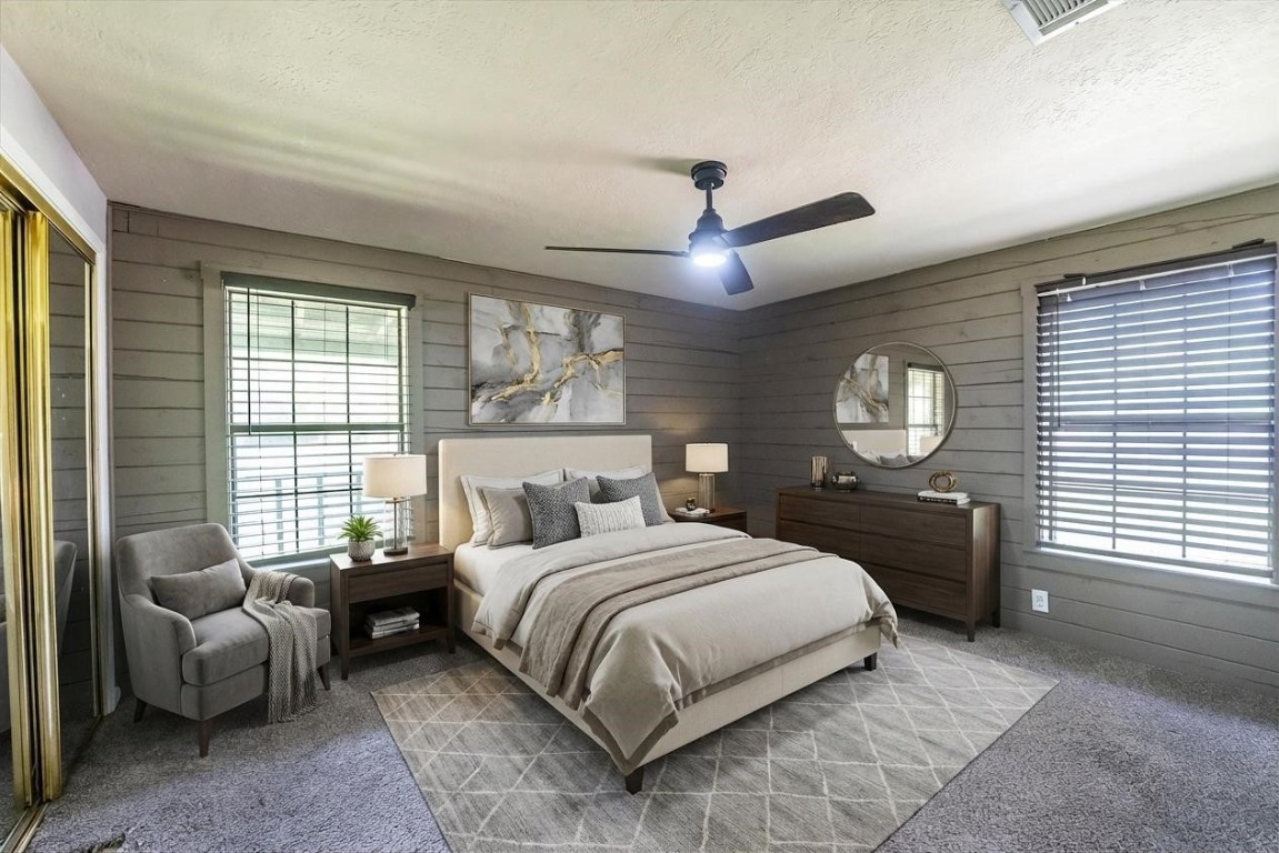 12049 Clark Lane Conroe, TX 77385 - Photo 20 of 40 a bedroom with a bed a chandelier and a window