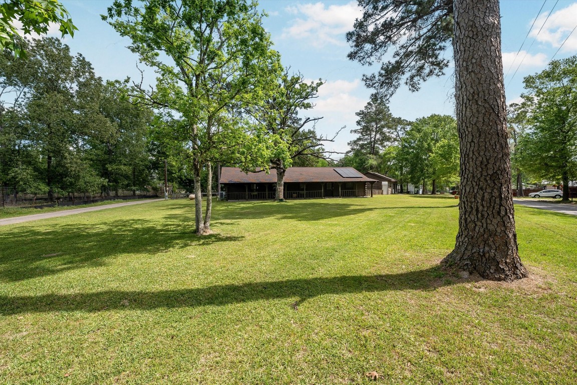 12049 Clark Lane Conroe, TX 77385 - Photo 2 of 40 a view of a house with a yard