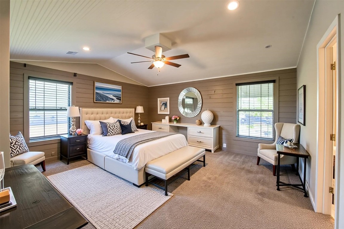 12049 Clark Lane Conroe, TX 77385 - Photo 21 of 40 a spacious bedroom with a large bed and a chandelier