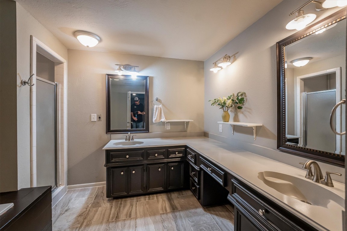 12049 Clark Lane Conroe, TX 77385 - Photo 22 of 40 a spacious bathroom with a granite countertop sink and a mirror