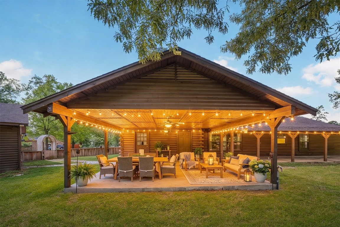 12049 Clark Lane Conroe, TX 77385 - Photo 25 of 40 a view of a patio with table and chairs potted plants and large tree
