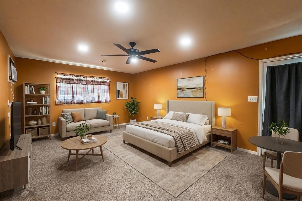 12049 Clark Lane Conroe, TX 77385 - Photo 27 of 40 a spacious bedroom with a bed a couch and a flat screen tv