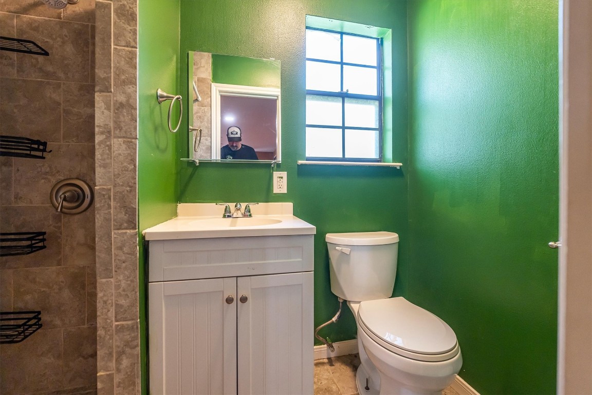 12049 Clark Lane Conroe, TX 77385 - Photo 28 of 40 a bathroom with a toilet a sink and mirror