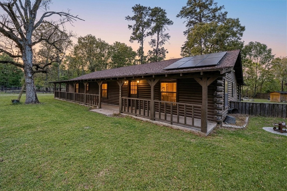 12049 Clark Lane Conroe, TX 77385 - Photo 3 of 40 a view of a house with wooden deck and a big yard