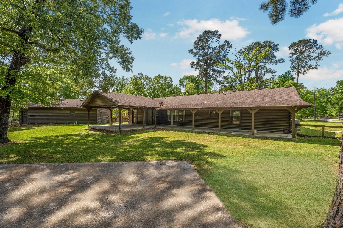 12049 Clark Lane Conroe, TX 77385 - Photo 33 of 40 a front view of a house with a yard