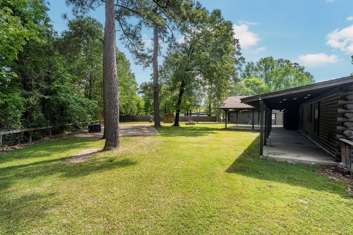 12049 Clark Lane Conroe, TX 77385 - Photo 34 of 40 a swimming pool with lots of tress in front of it