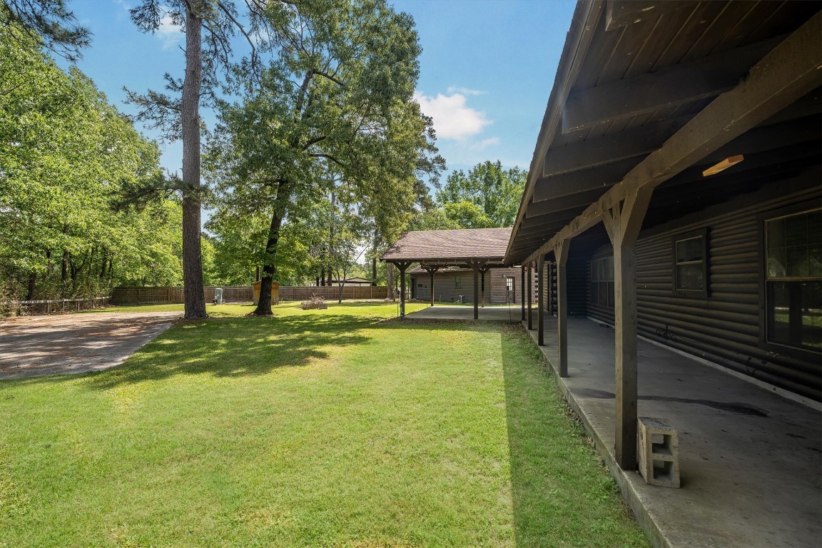 12049 Clark Lane Conroe, TX 77385 - Photo 35 of 40 a view of a house with a backyard