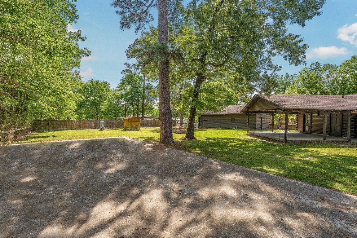 12049 Clark Lane Conroe, TX 77385 - Photo 36 of 40 a view of a house with a yard
