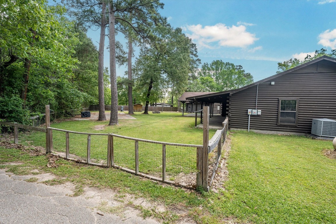 12049 Clark Lane Conroe, TX 77385 - Photo 38 of 40 a view of a house with backyard and sitting area