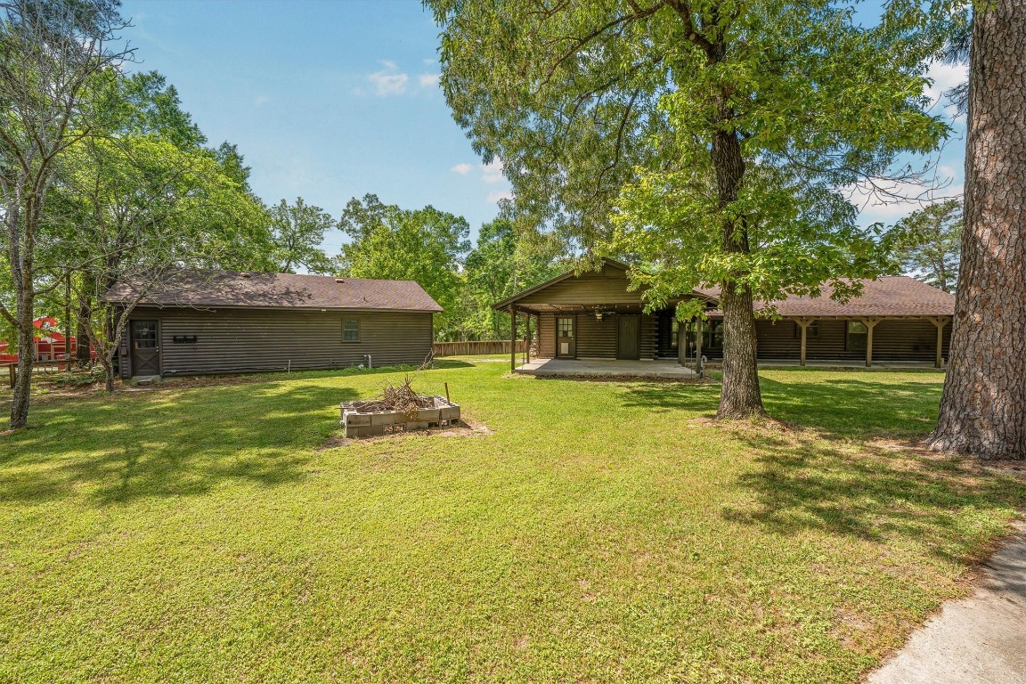 12049 Clark Lane Conroe, TX 77385 - Photo 39 of 40 a front view of a house with a yard