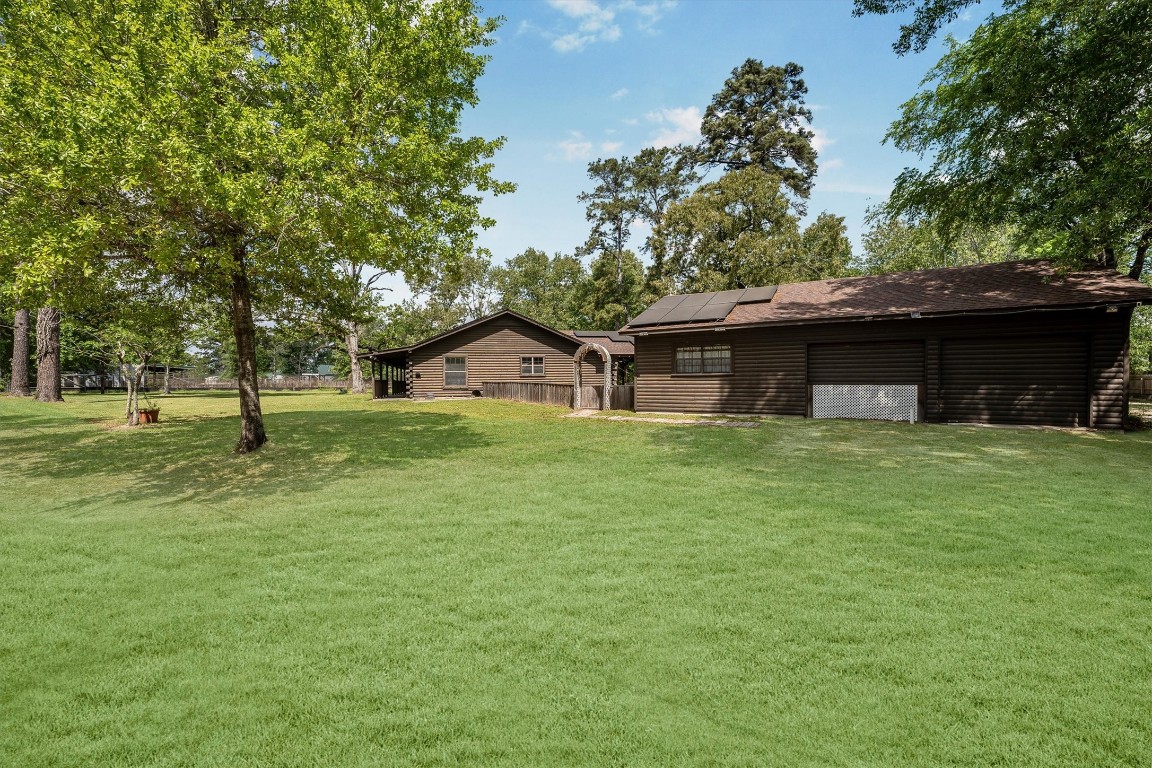 12049 Clark Lane Conroe, TX 77385 - Photo 40 of 40 a front view of a house with a yard and trees