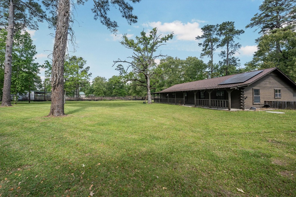 12049 Clark Lane Conroe, TX 77385 - Photo 4 of 40 a front view of a house with a garden