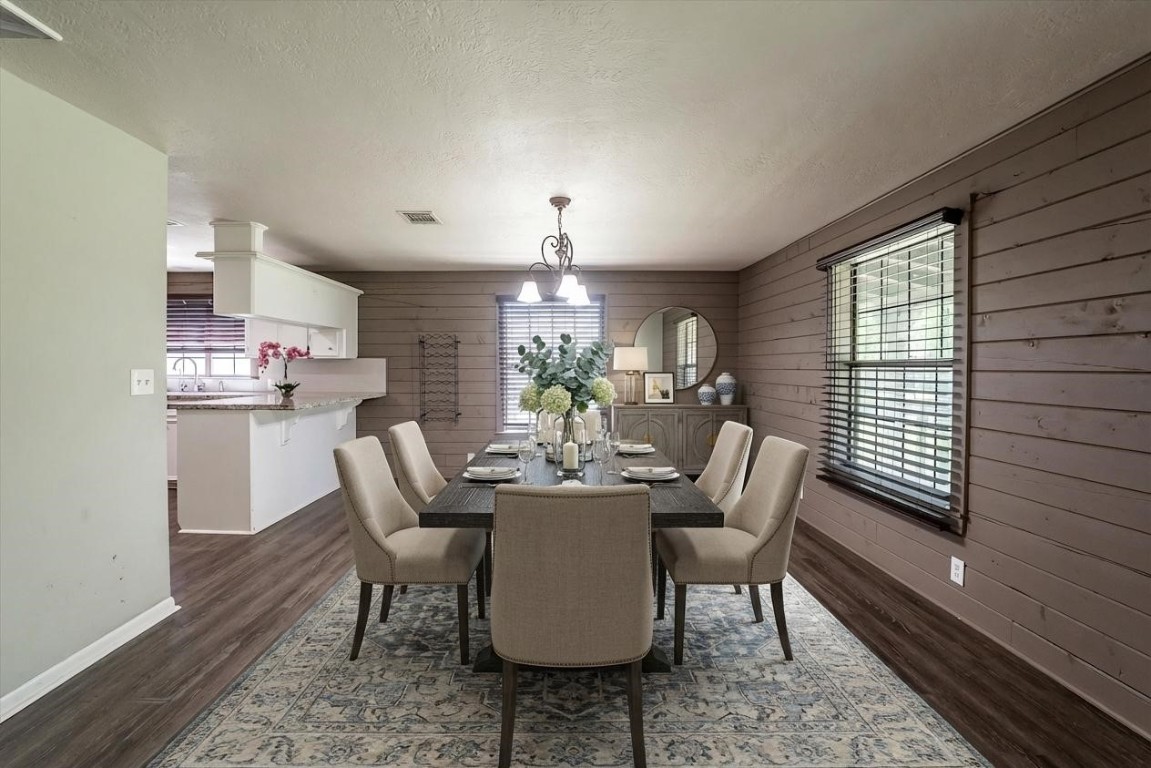 12049 Clark Lane Conroe, TX 77385 - Photo 8 of 40 a dining room with furniture a rug and wooden floor