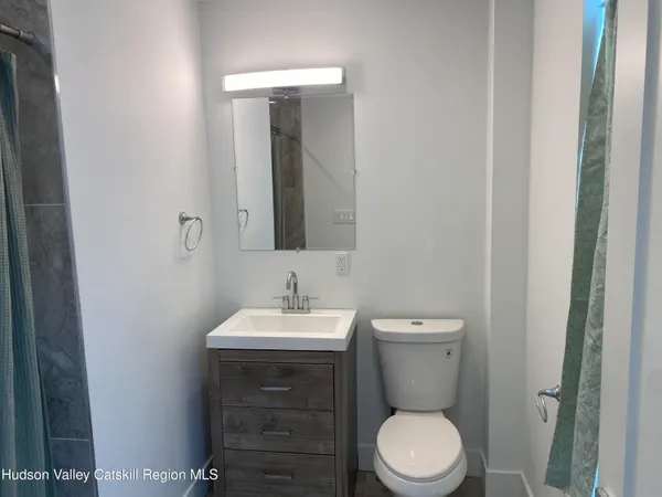 a bathroom with a glass shower door