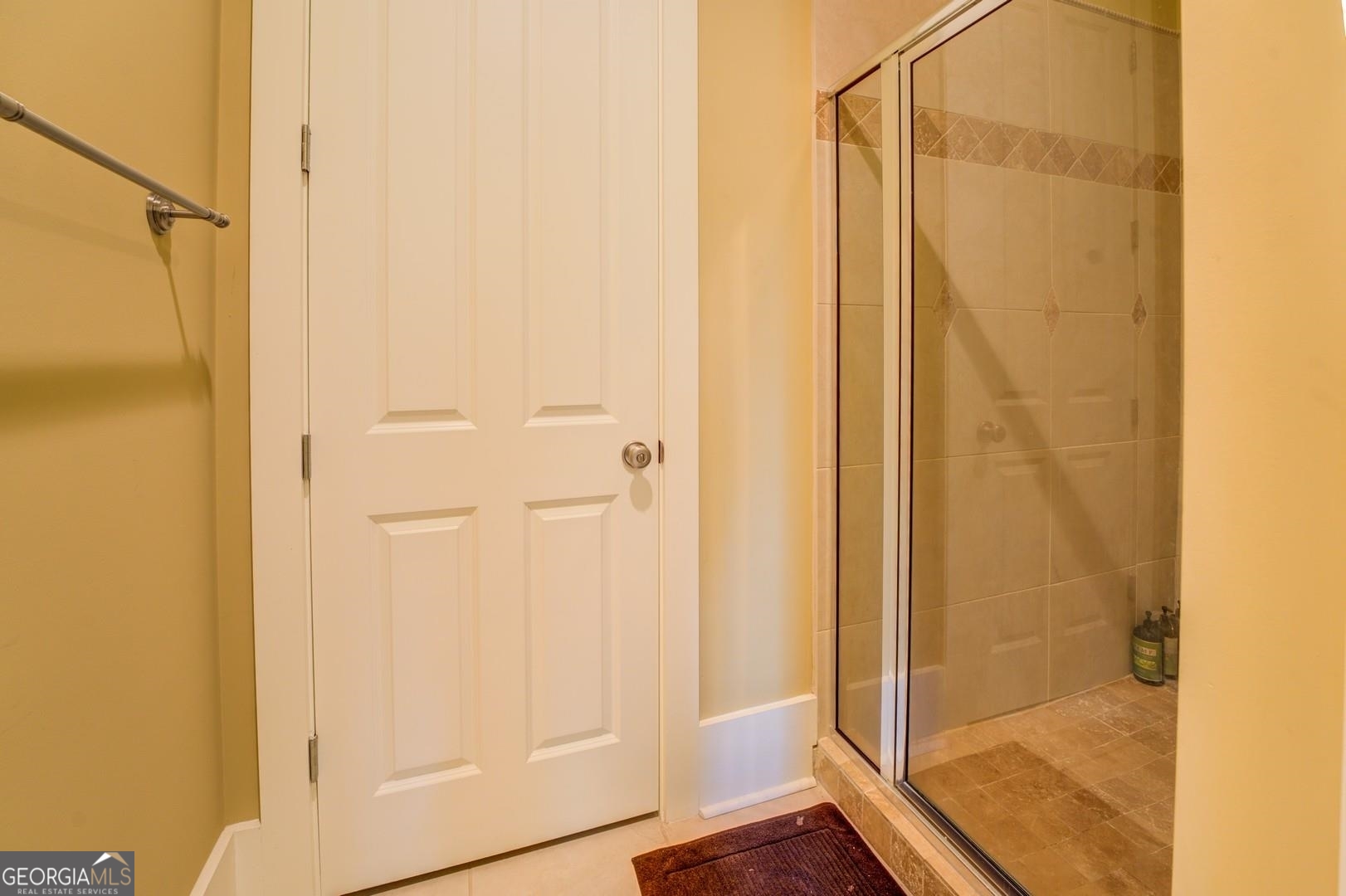 4165 Raphael Street Covington, GA 30014 - Photo 14 of 25 a bathroom with a glass shower door