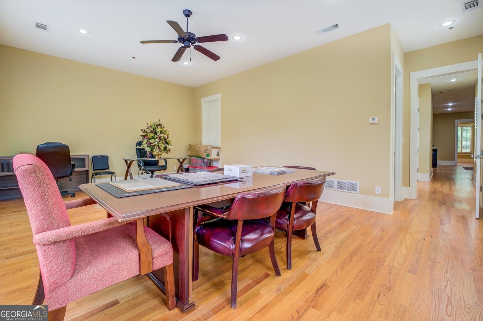 4165 Raphael Street Covington, GA 30014 - Photo 16 of 25 a dining room with a wooden table and chairs