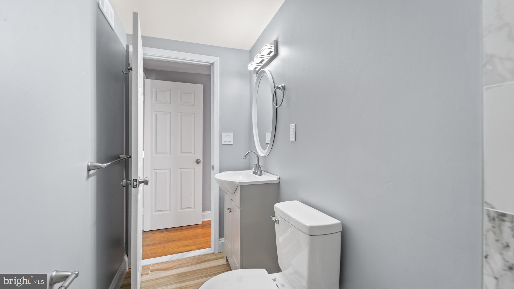 3605 Chapman Road Randallstown, MD 21133 - Photo 44 of 65 a bathroom with a toilet sink and mirror