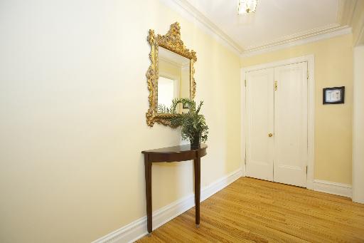 1255 North State Parkway, Unit 5D Chicago, IL 60610 - Photo 2 of 16 a view of a hallway with wooden floor and a bathroom