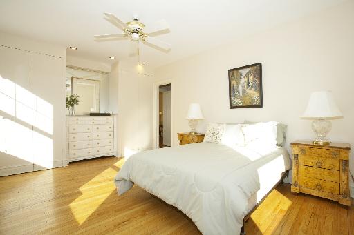 1255 North State Parkway, Unit 5D Chicago, IL 60610 - Photo 11 of 16 a bedroom with a bed and wooden floor