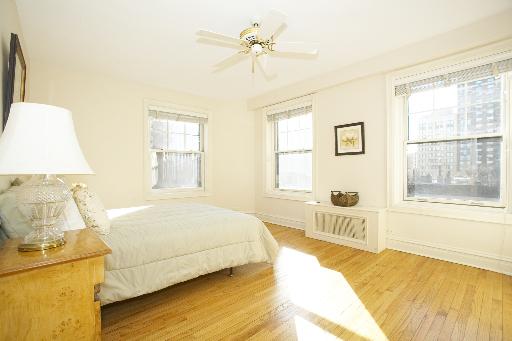 1255 North State Parkway, Unit 5D Chicago, IL 60610 - Photo 9 of 16 a bedroom with a bed and wooden floor