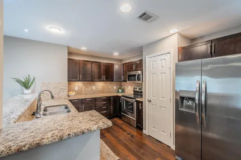 a kitchen with a refrigerator sink and stove