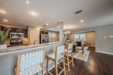 a large kitchen with a table and chairs