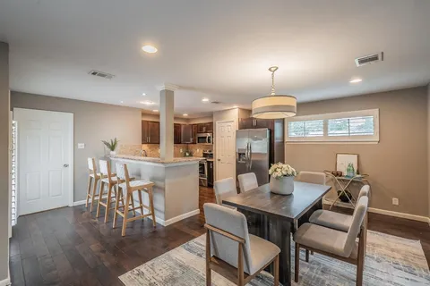a view of a dining room with furniture and wooden floor