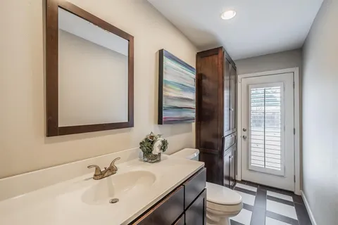 a bathroom with a sink toilet and mirror