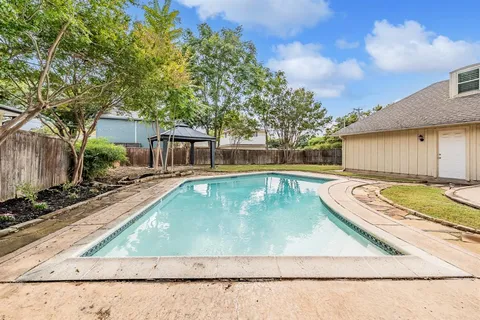 a view of a swimming pool with a patio