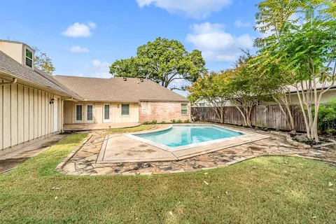 a view of a house with swimming pool and sitting area