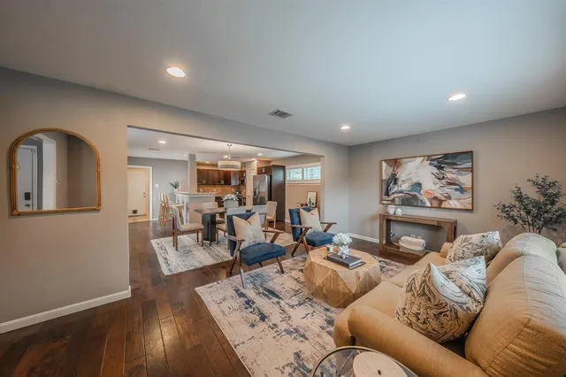 a living room with furniture and wooden floor