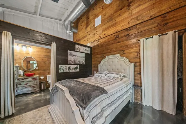 a bed sitting in a bedroom next to a window