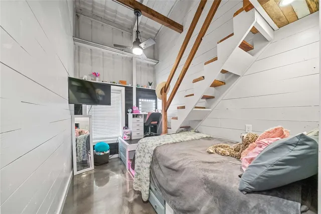 a bed room with a bed and a television