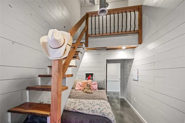 a bedroom with bed and wooden floor