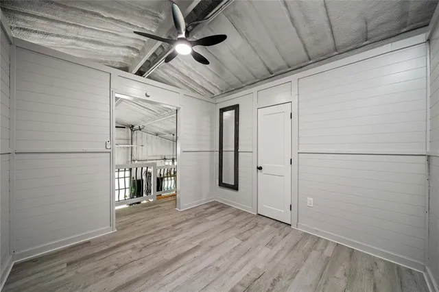 a view of empty room with wooden floor