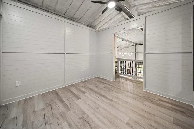 a view of a room with wooden floor
