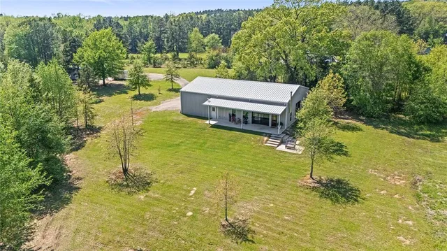 a view of backyard of house with outdoor seating