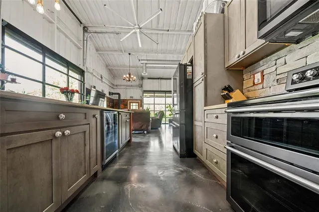 a kitchen with stainless steel appliances lots of counter space and a window