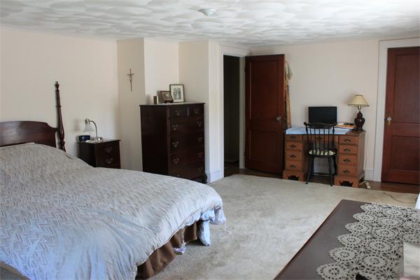 253 Lincoln Road Lincoln, MA 01773 - Photo 14 of 14 a bedroom with a bed and a television