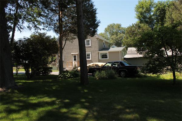 253 Lincoln Road Lincoln, MA 01773 - Photo 7 of 14 a front view of a house with a garden
