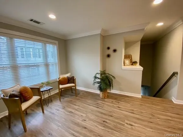 a living room with furniture window and wooden floor