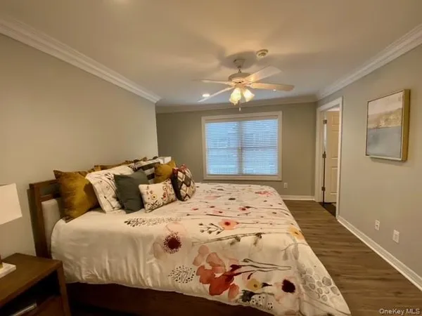 a bedroom with a large bed and a window