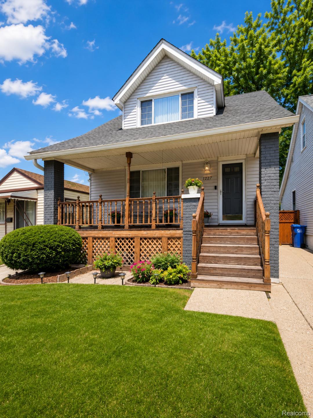 11227 Rivard Avenue Warren, MI 48089 - Photo 1 of 44 Two-story residence with a covered front porch featuring wood railings, stairs, and lattice skirting