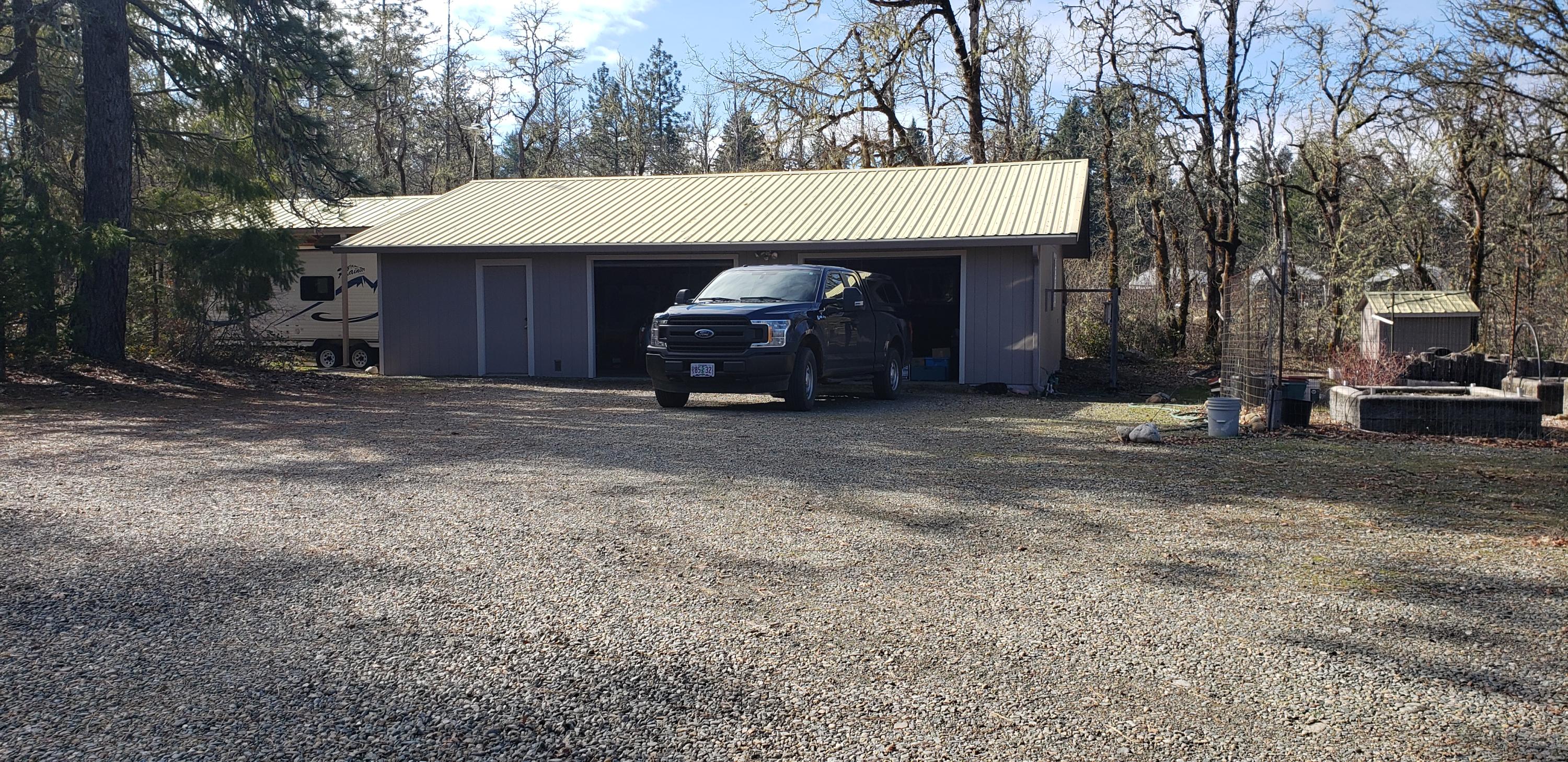 5865 Rockydale Road Cave Junction, OR 97523 - Photo 2 of 38 garage (double) with workshop area on left side.