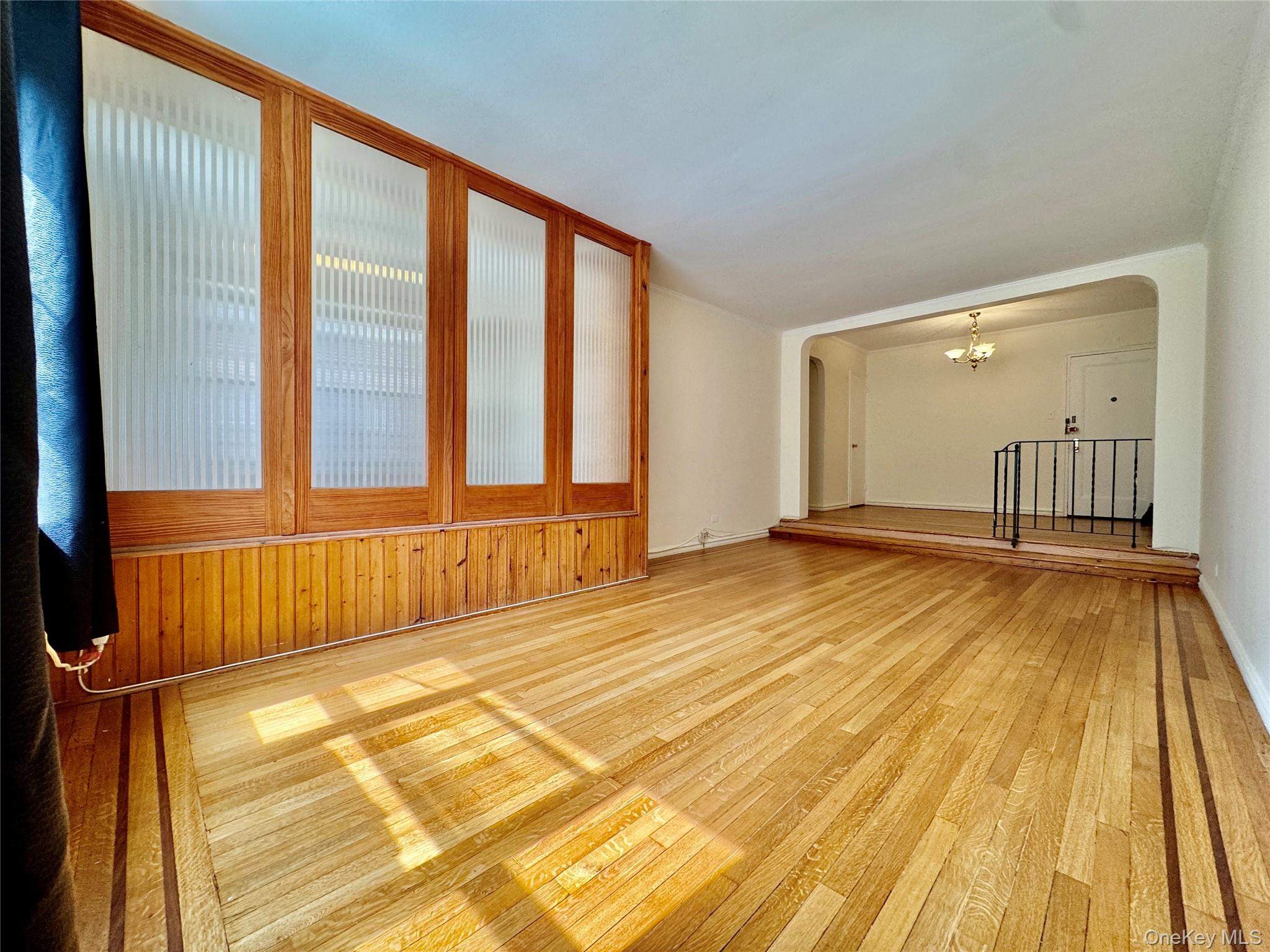 113-14 72nd Road, Unit 1M Queens, NY 11375 - Photo 6 of 20 a view of a room with wooden floor and windows