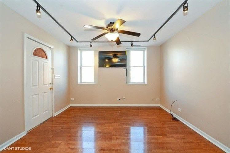 1631 West 18th Street, Unit 2 Chicago, IL 60608 - Photo 7 of 7 wooden floor in an empty room with a window