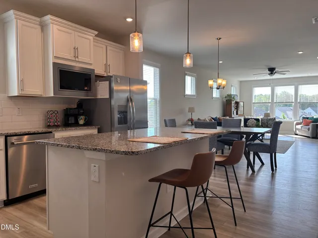 a kitchen with stainless steel appliances granite countertop a stove a sink and a granite counter tops