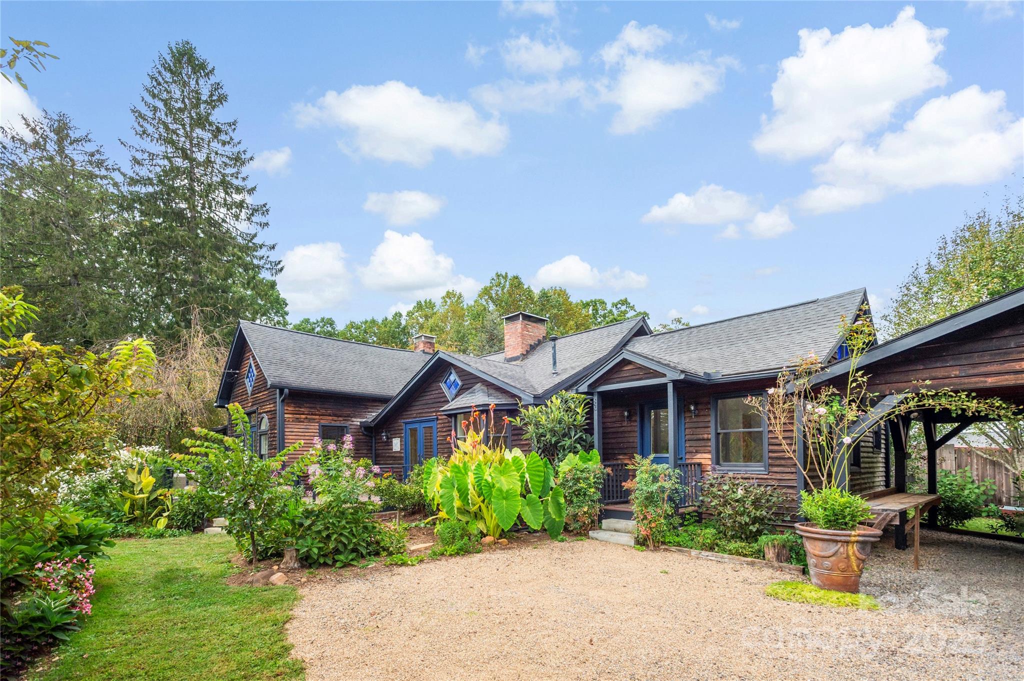 a front view of a house with a garden