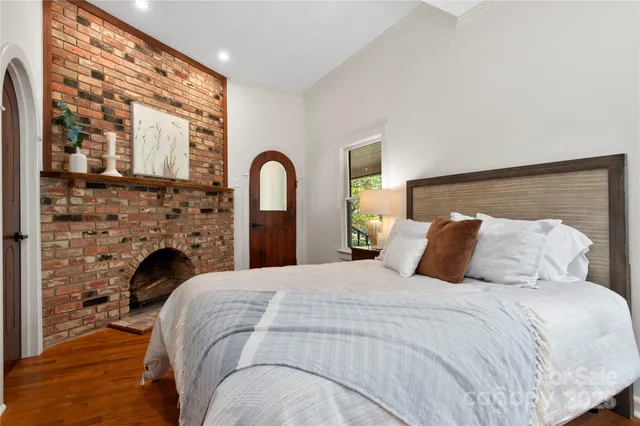 a bedroom with a bed and a fireplace